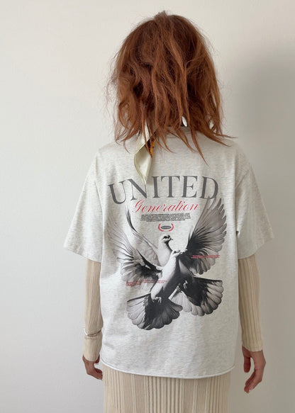 Person wearing a white t-shirt with a christian graphic design of two doves 